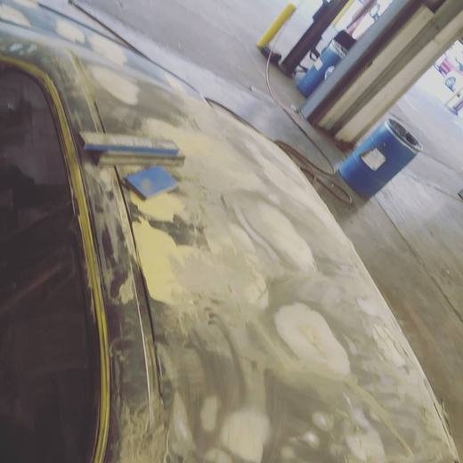 Body filler and sanding on a car roof before paint