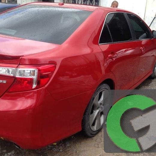 A repaired red sedan with fresh paint