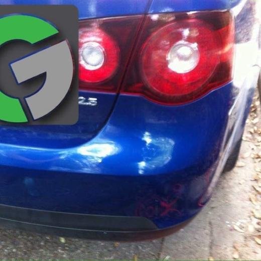 The same blue car with the rear bumper smooth after repair