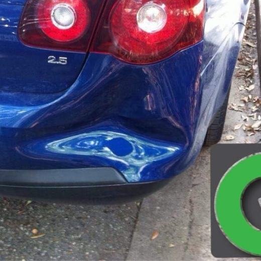 Blue car with a dent in the rear bumper before repair